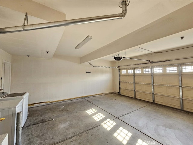 garage featuring a garage door opener and washer / dryer