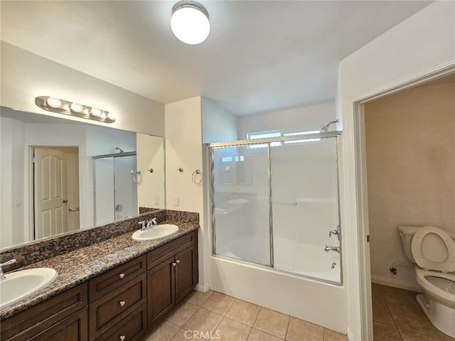 full bathroom with vanity, tile patterned floors, enclosed tub / shower combo, and toilet