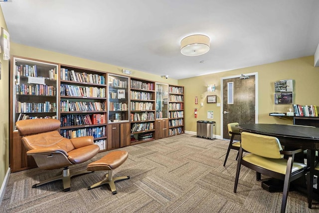 sitting room featuring light colored carpet