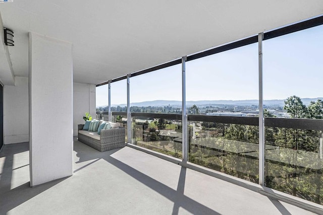 unfurnished sunroom with plenty of natural light and a mountain view