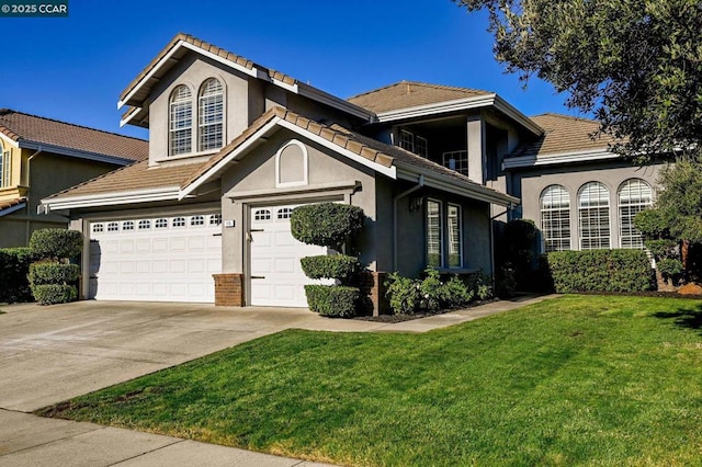 front facade featuring a garage and a front yard