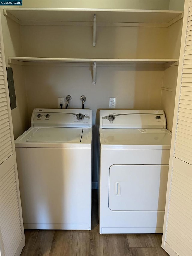 laundry area featuring washing machine and dryer and dark hardwood / wood-style floors