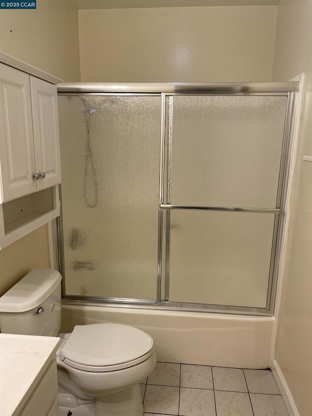 full bathroom featuring vanity, tile patterned floors, enclosed tub / shower combo, and toilet