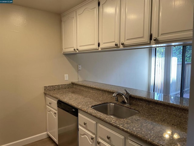 kitchen with sink, white cabinetry, dark stone countertops, dark hardwood / wood-style floors, and stainless steel dishwasher