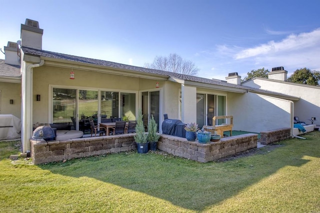 rear view of property with a yard