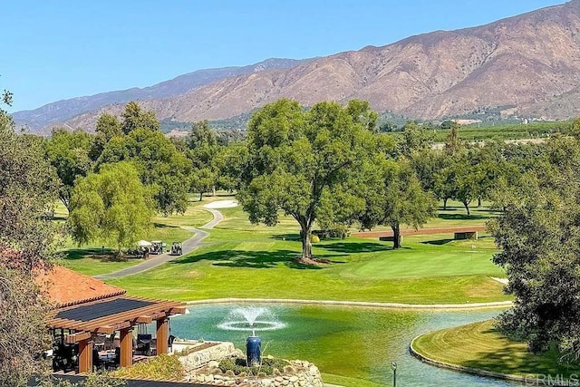 surrounding community with a water and mountain view