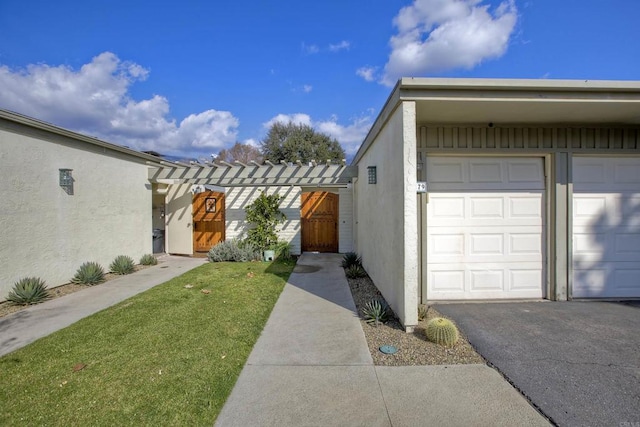 view of home's exterior featuring a garage and a lawn