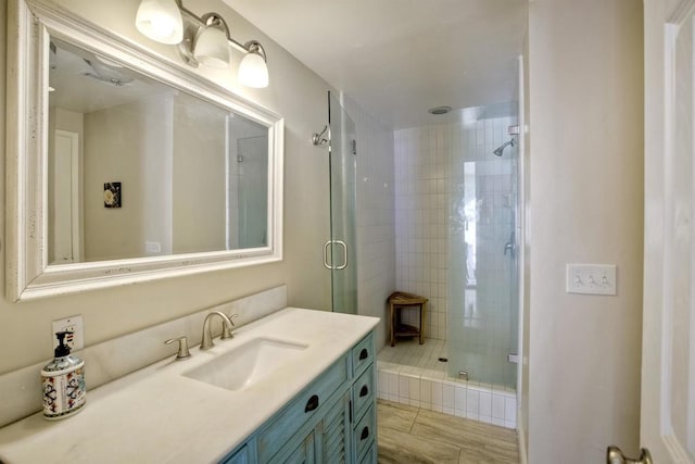 bathroom featuring tile patterned flooring, vanity, and a shower with shower door