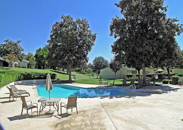 view of pool featuring a yard and a patio area