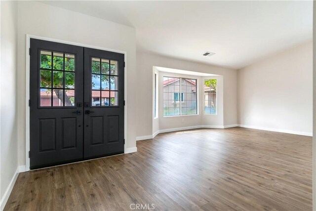 foyer entrance with french doors and wood-type flooring