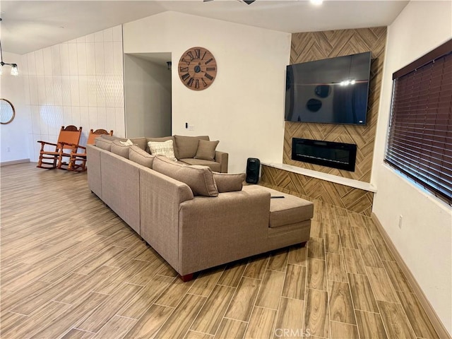 living room with a large fireplace and vaulted ceiling