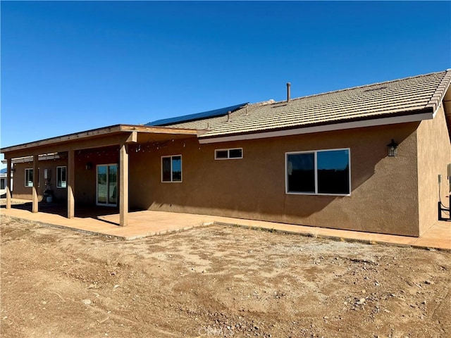 rear view of property featuring a patio area