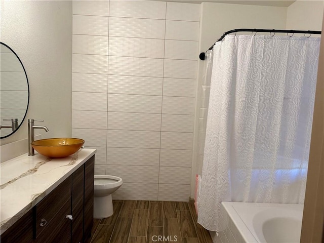 full bathroom featuring vanity, shower with separate bathtub, tile walls, and toilet