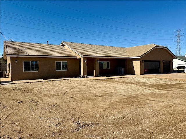 single story home with a garage and central AC