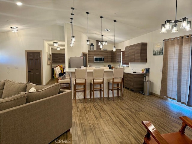 interior space featuring hardwood / wood-style flooring and lofted ceiling