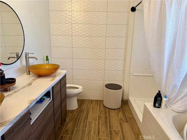 bathroom featuring toilet, vanity, and a shower with shower curtain