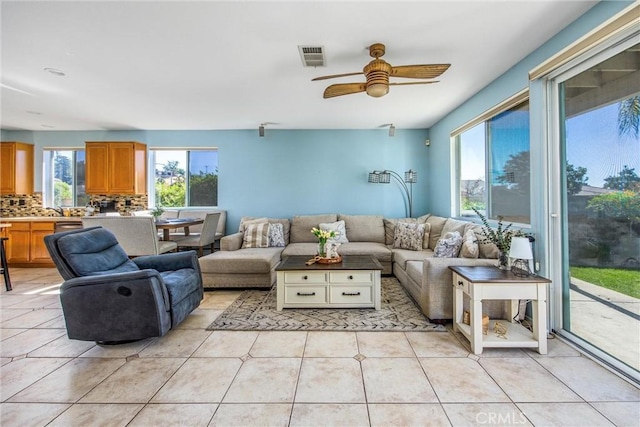 living room with light tile patterned floors and ceiling fan