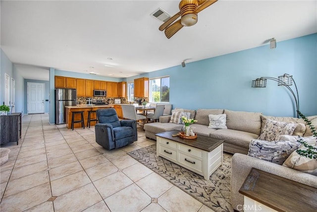 living room featuring light tile patterned floors and ceiling fan