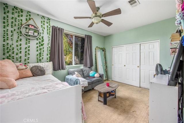 carpeted bedroom with a closet and ceiling fan