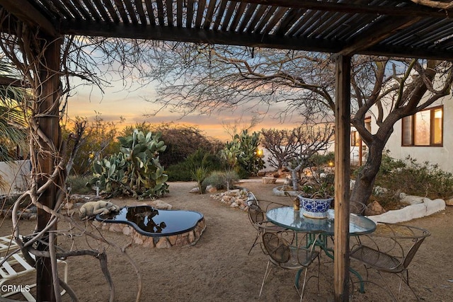 view of patio terrace at dusk