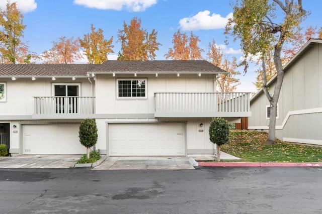 view of property with a garage and a balcony