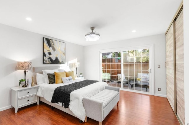 bedroom with hardwood / wood-style flooring and access to exterior