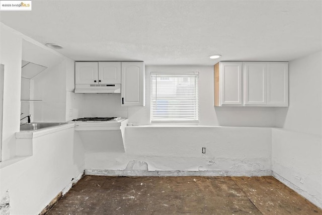 kitchen featuring sink, white gas stovetop, and white cabinets