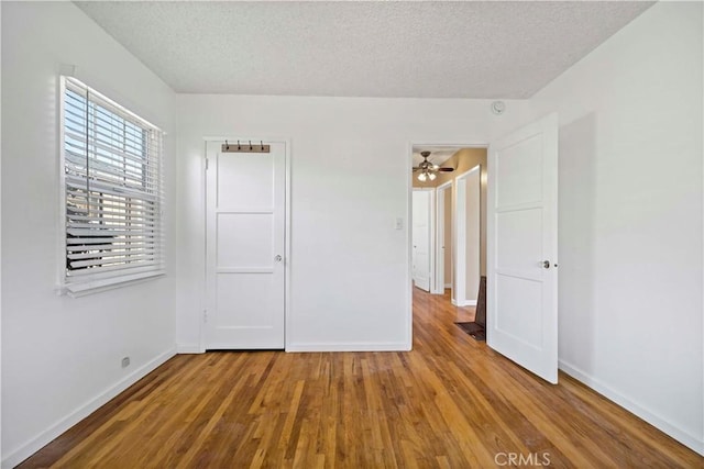 unfurnished bedroom featuring hardwood / wood-style flooring and a textured ceiling