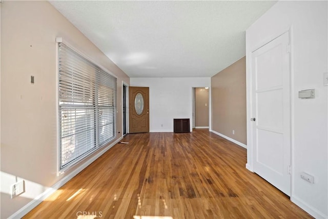 unfurnished living room featuring wood-type flooring