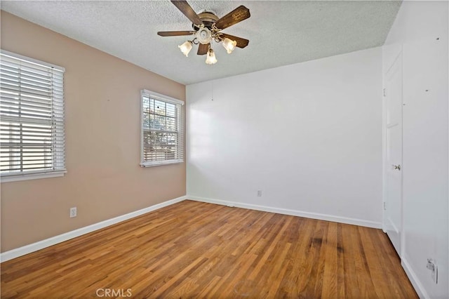 spare room featuring hardwood / wood-style floors, a textured ceiling, and ceiling fan