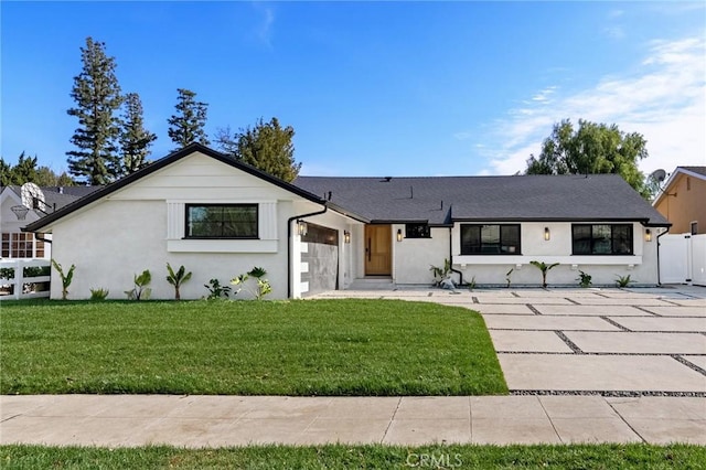 view of front of property featuring a garage and a front yard