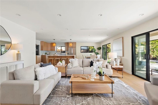 living room featuring plenty of natural light and light hardwood / wood-style flooring