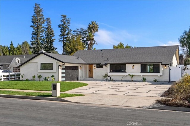 view of front of home featuring a garage and a front lawn