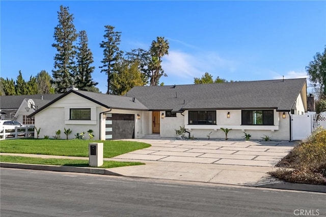 view of front facade featuring a garage and a front lawn