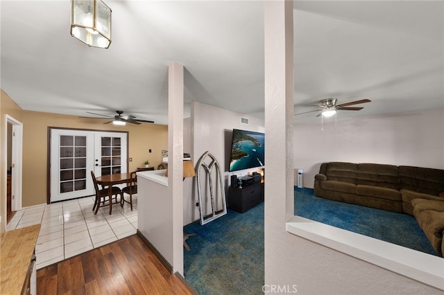 living room with radiator, tile patterned floors, french doors, and ceiling fan