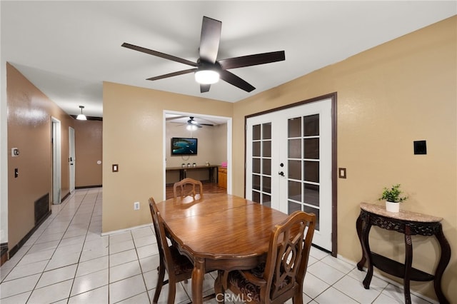 tiled dining room featuring french doors