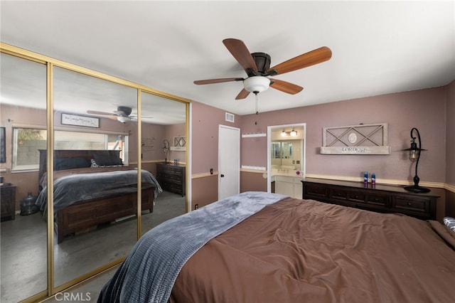 bedroom featuring a closet, ceiling fan, and ensuite bath