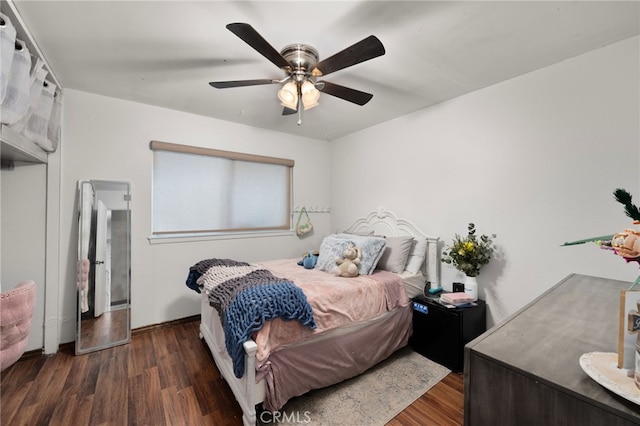 bedroom with dark wood-type flooring and ceiling fan