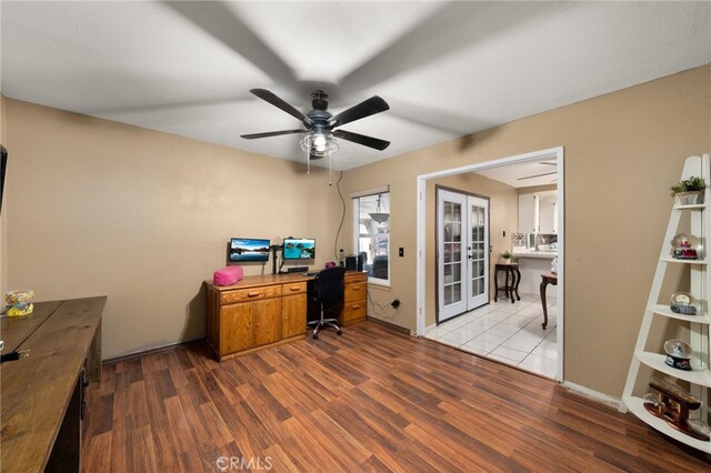 office with french doors, ceiling fan, and light hardwood / wood-style floors