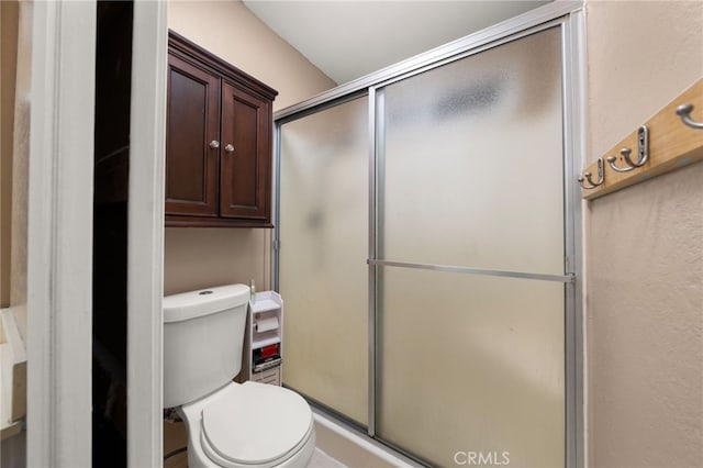 bathroom with toilet and walk in shower