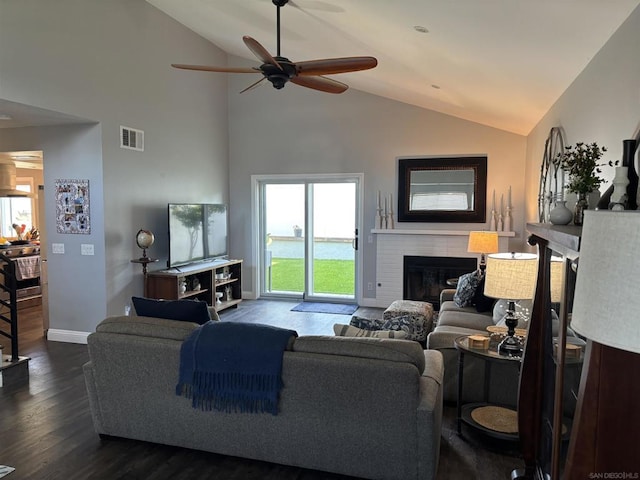 living room with ceiling fan, high vaulted ceiling, dark wood-type flooring, and a fireplace