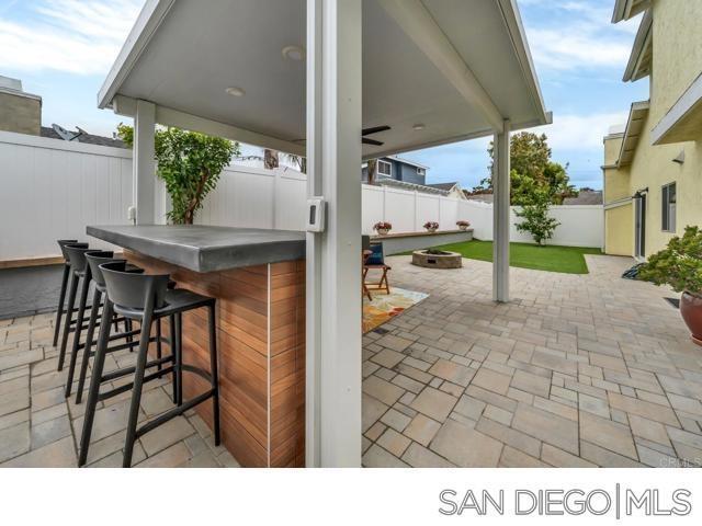 view of patio / terrace featuring an outdoor bar and a fire pit