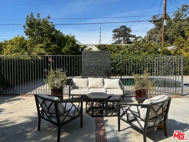 view of patio with an outdoor living space and a fenced in pool