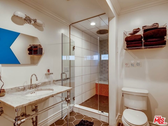 bathroom with tiled shower, toilet, sink, ornamental molding, and tile patterned flooring