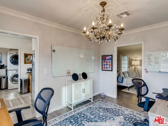 office with an inviting chandelier, hardwood / wood-style floors, crown molding, and stacked washing maching and dryer