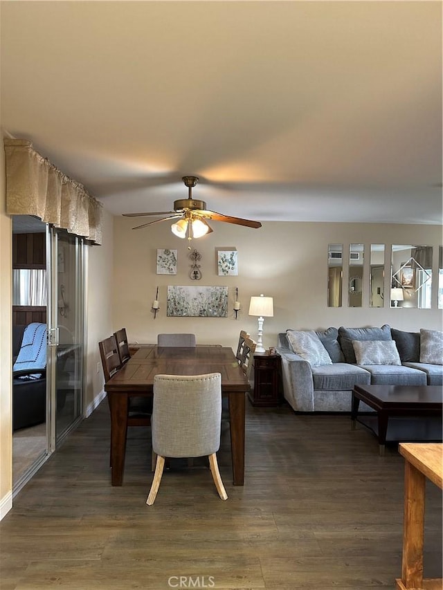 dining space with dark hardwood / wood-style flooring and ceiling fan