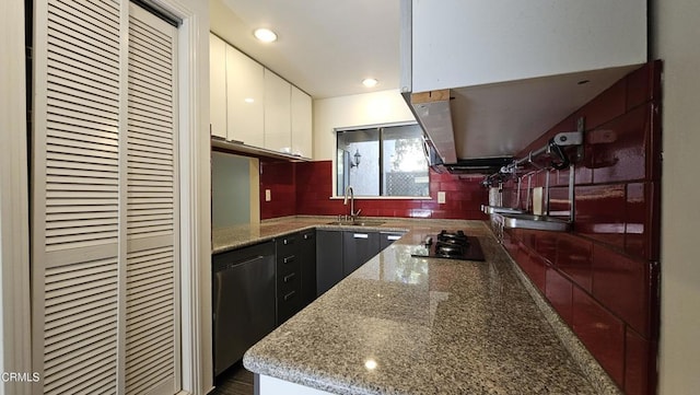 kitchen with sink, white cabinetry, black appliances, light stone countertops, and decorative backsplash