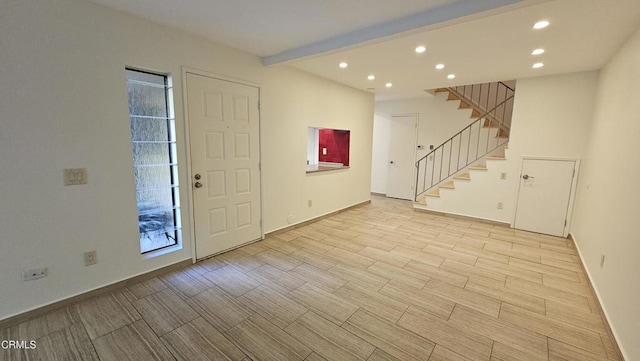 foyer featuring beam ceiling