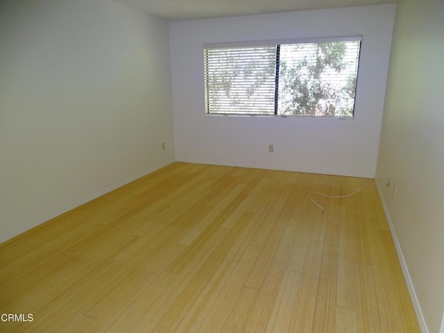 spare room with light wood-type flooring