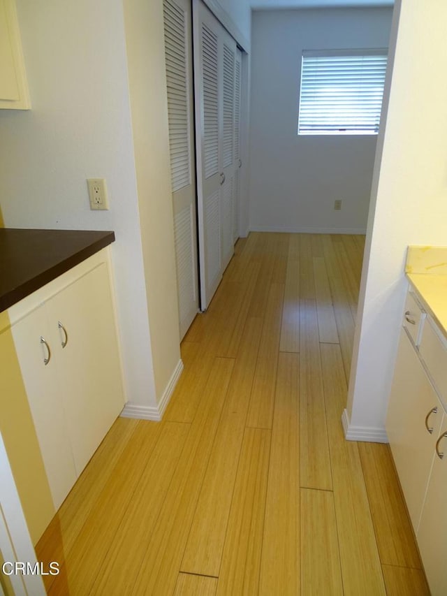 corridor with light wood-type flooring